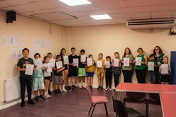 Group of children lined up in room.