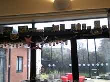 Handmade Christmas decorations hanging from a window
