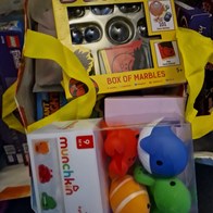 A bag of colourful children toys.