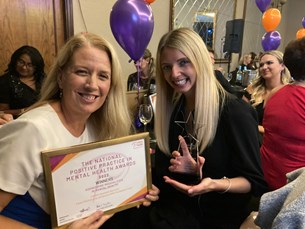 Claudia Foakes and Dr Jennifer Scott smiling holding award