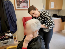 Hairdresser, Jessica Black, giving a patient a haircut