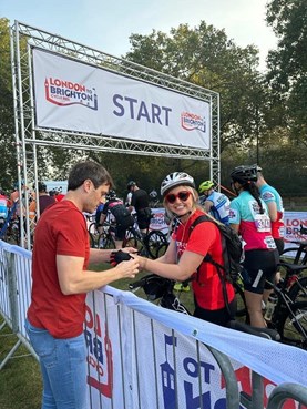 Woman smiling at the start line of a bike race.