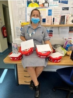 Nurse holding box of chocolates
