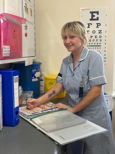Photo of Nicole Mithcell in her light blue NHS uniform