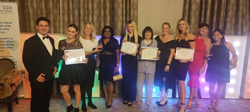 Personality disorder and complex needs team group photo holding awards
