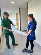 Two allied health professional students talking with each other