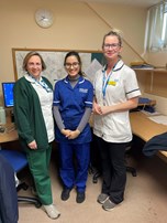 Three allied health professionals smiling at the camera