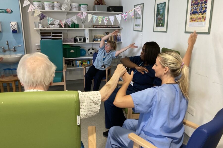 Therapy-staff-with-patients-take-part-in-a-music-and-singing-session-on-Plane-Ward