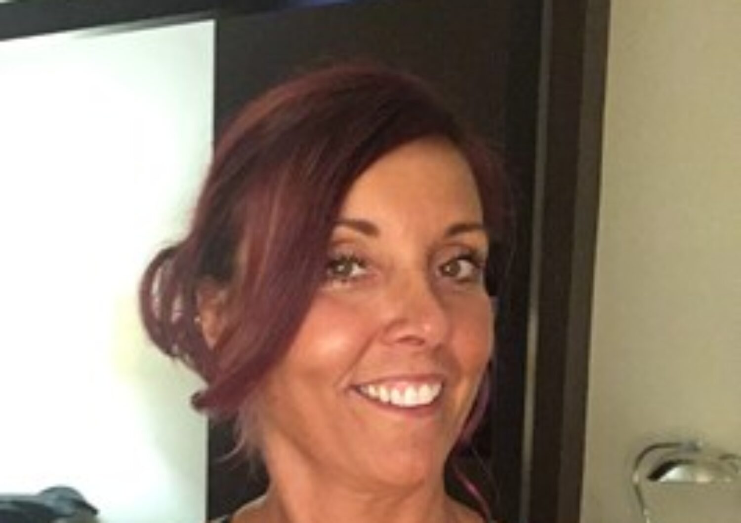 Caucasian woman smiling at the camera.