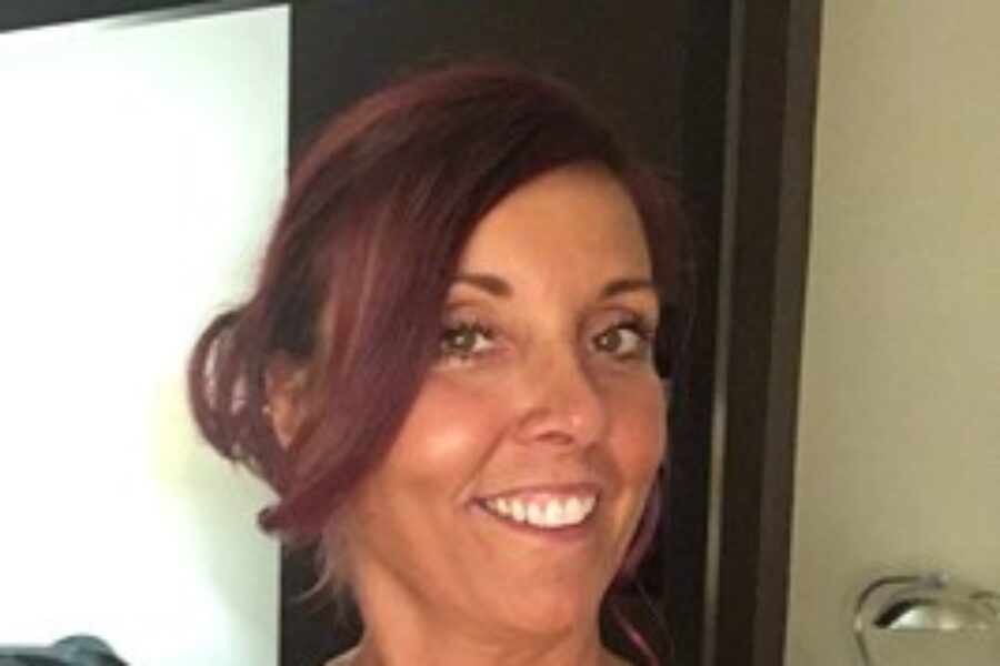 Caucasian woman smiling at the camera.