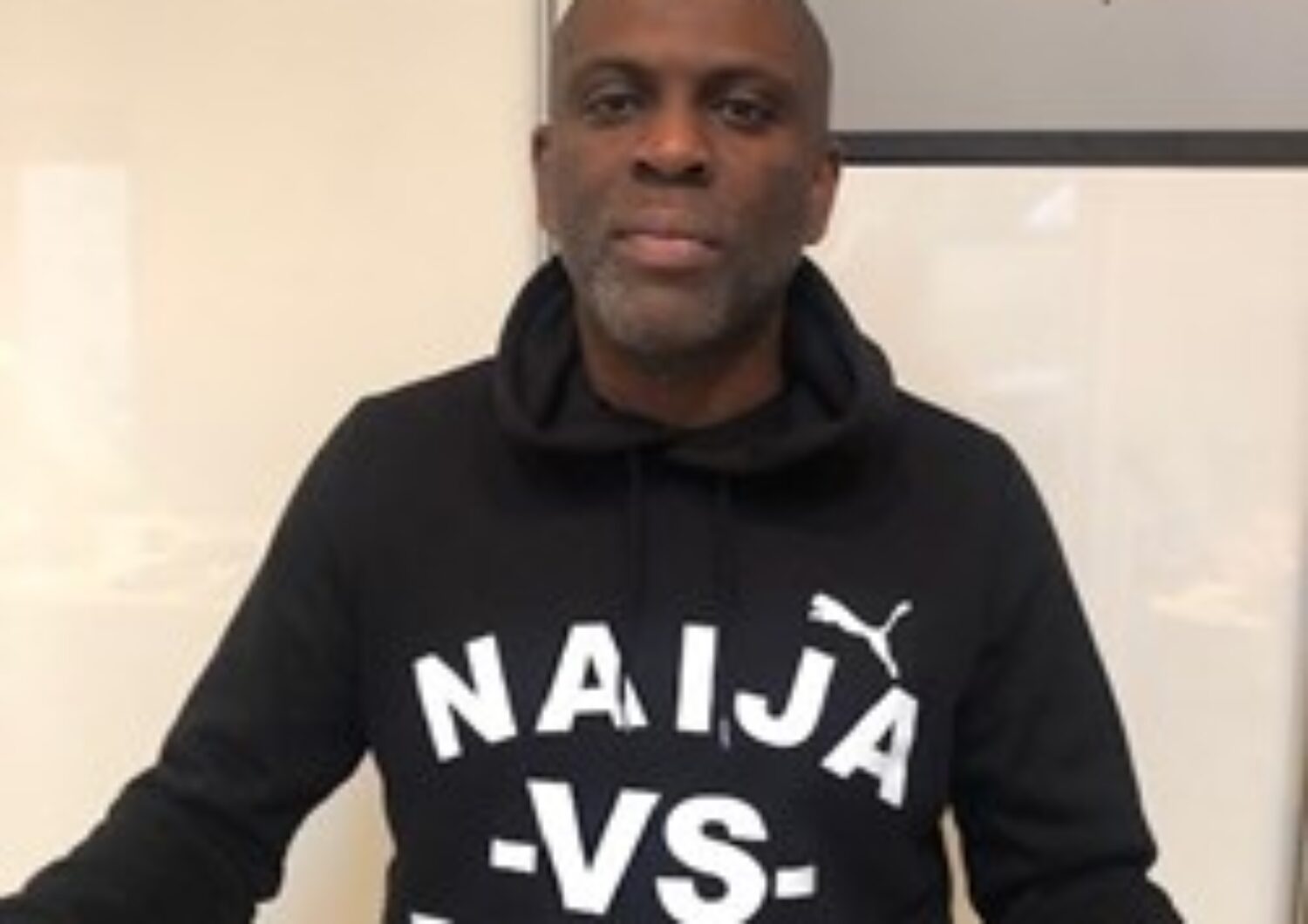 Black man wearing a black sweatshirt.