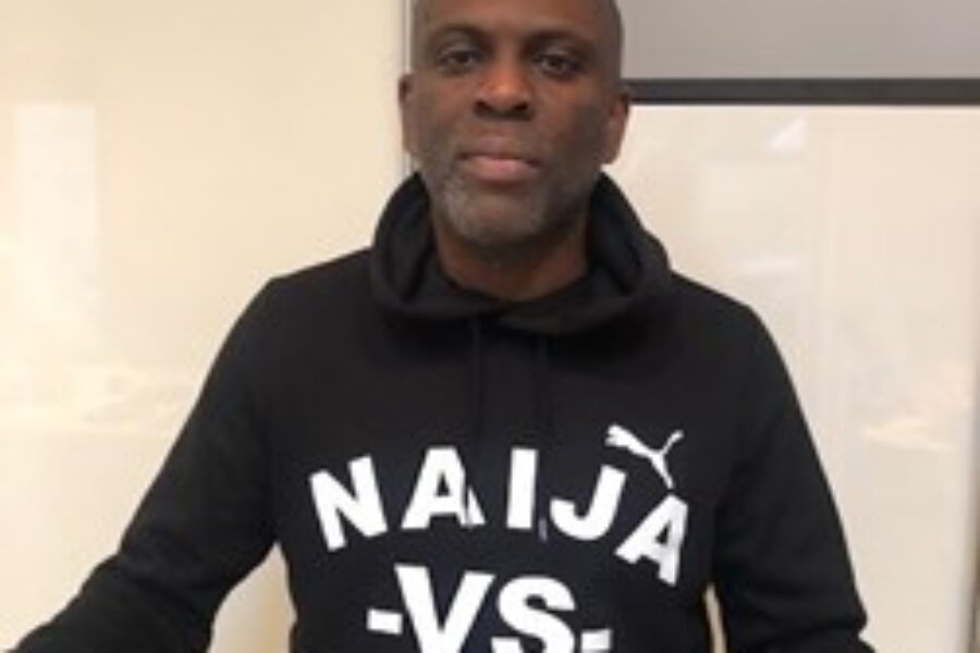 Black man wearing a black sweatshirt.