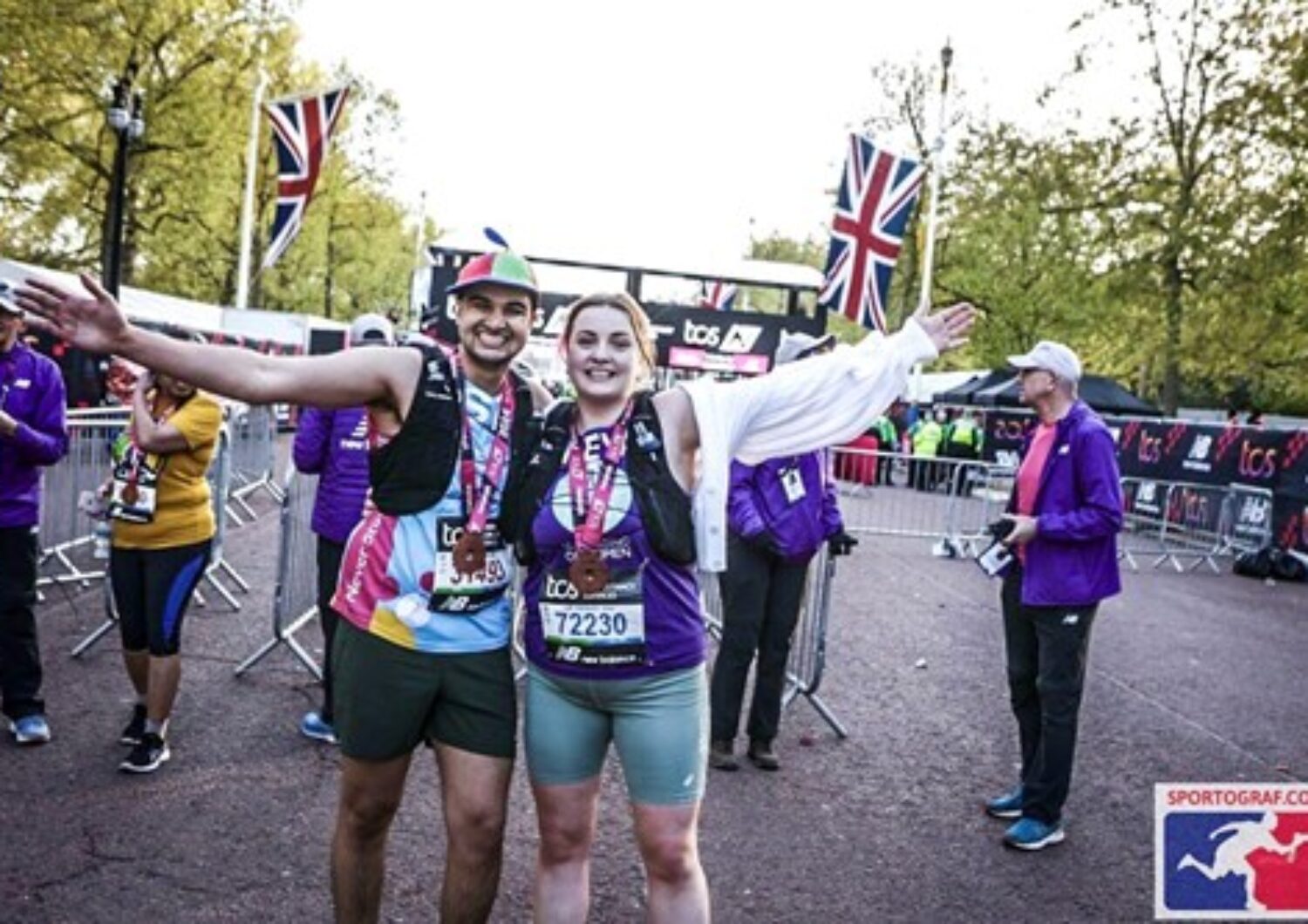 Man and a woman smiling at the camera after running the london marathon to raise money for charity