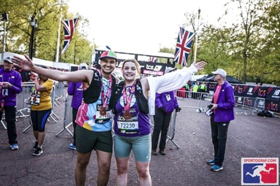 Man and a woman smiling at the camera after running the london marathon to raise money for charity