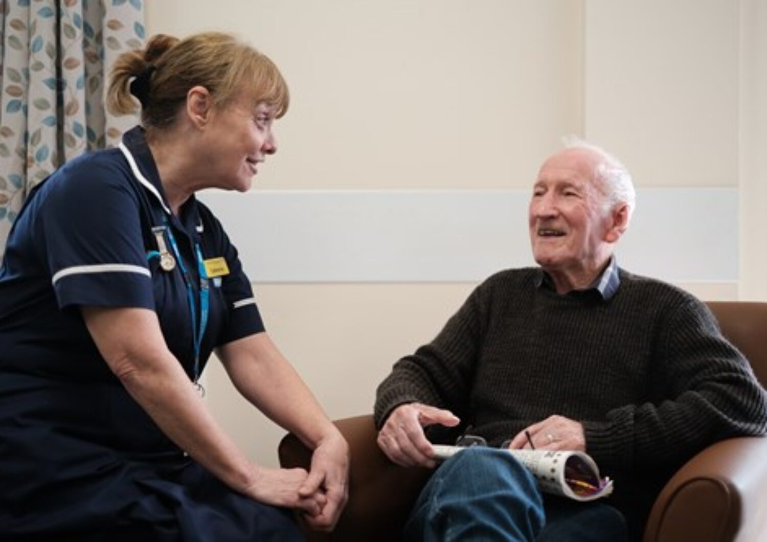 Nurse talking with an elderly patient
