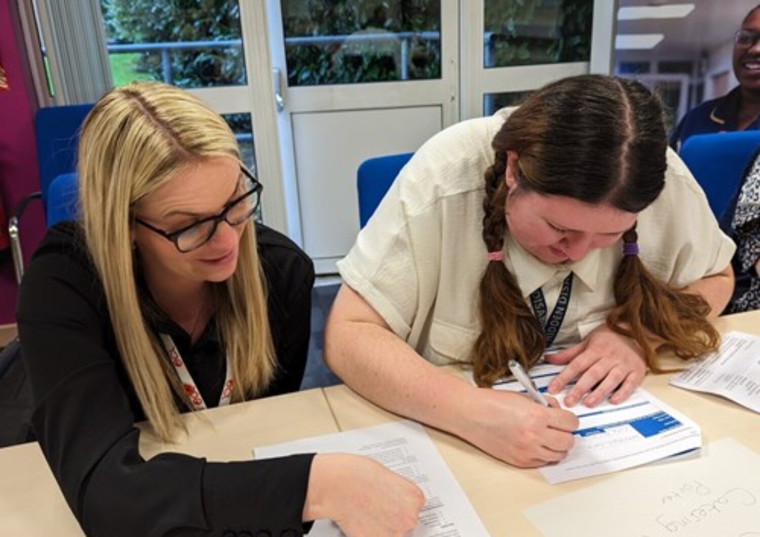 Two women looking at recruitment paperwork