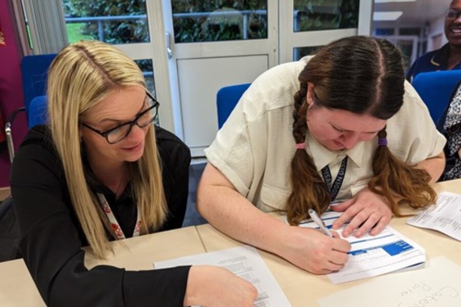 Two women looking at recruitment paperwork