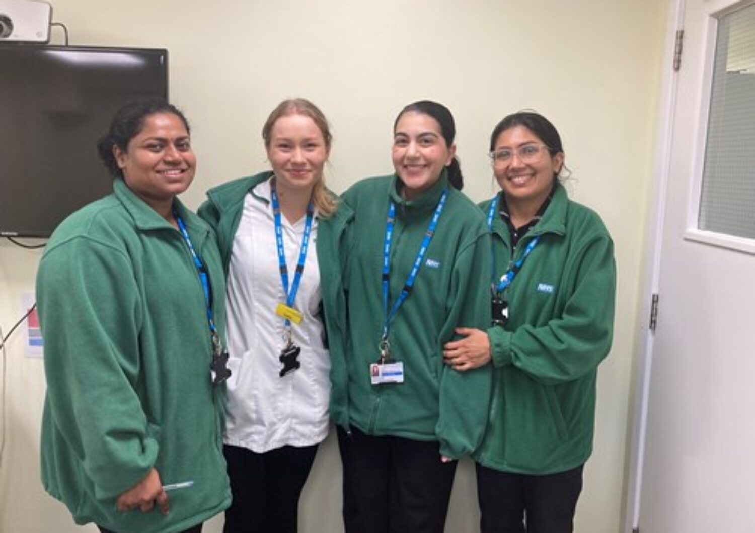 Four pharmacy apprentices smiling.