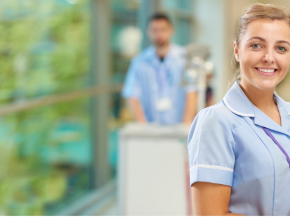 Young woman in a blue nursing uniform smiling