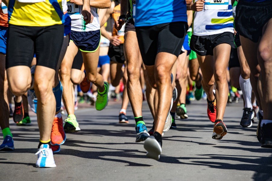 The bottom half of a group of runners running